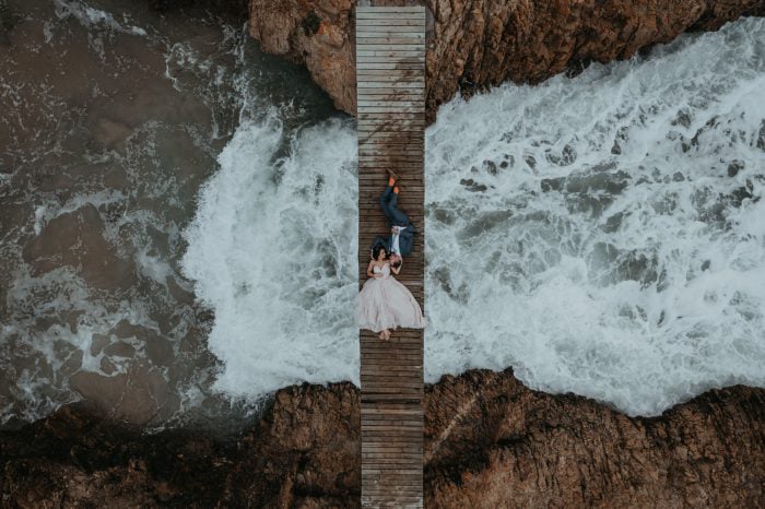 Wedding couple photographed above the ocean